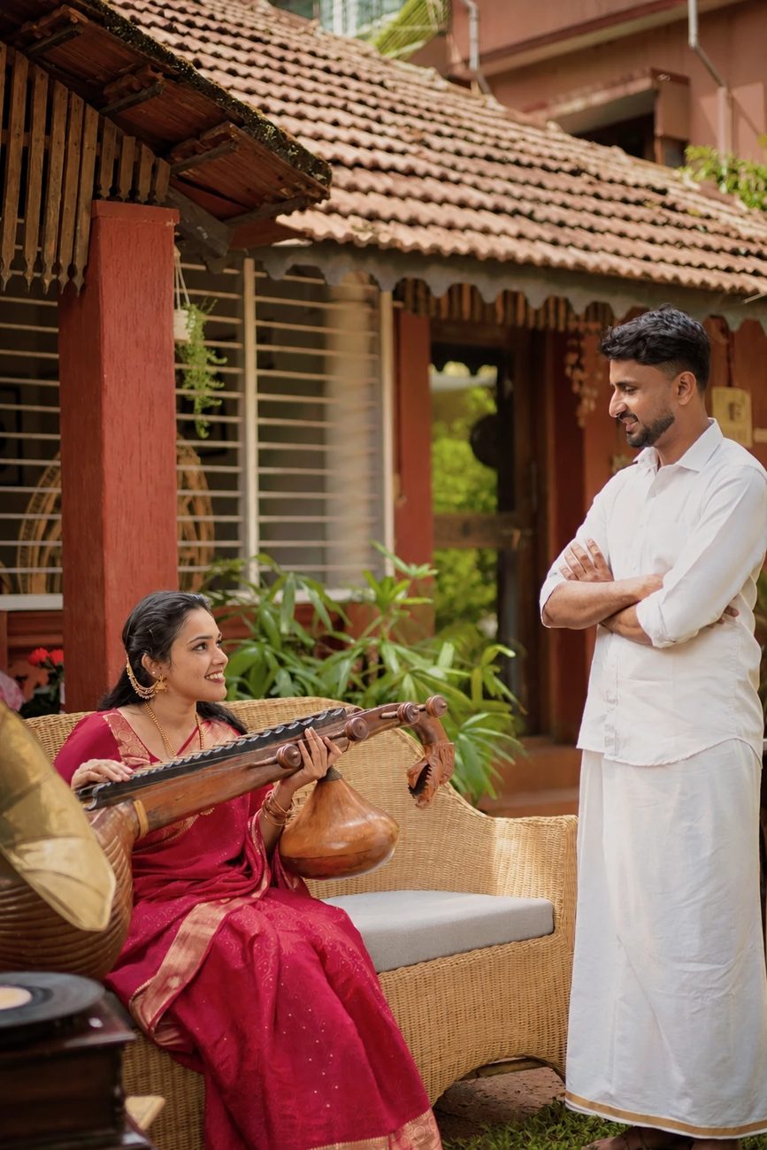 Manisha playing the veena while Pawan watches