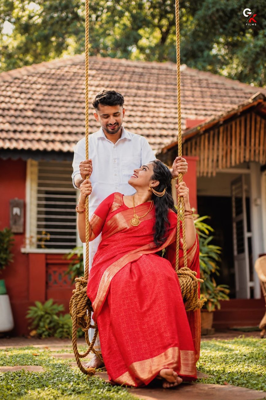 Pawan pushing Manisha on a rope swing