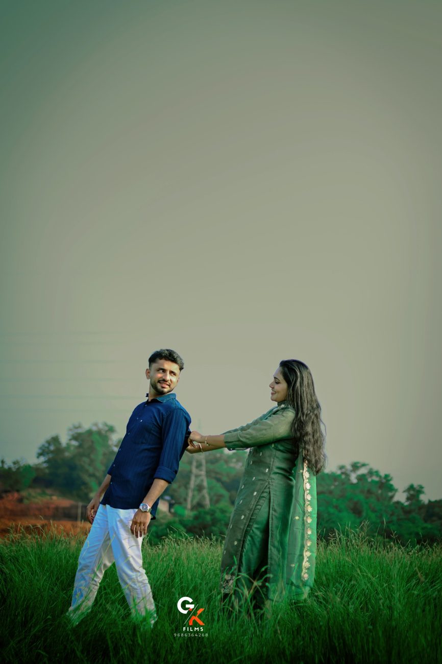 Manisha playfully pulling Pawan by the sleeve in a green field